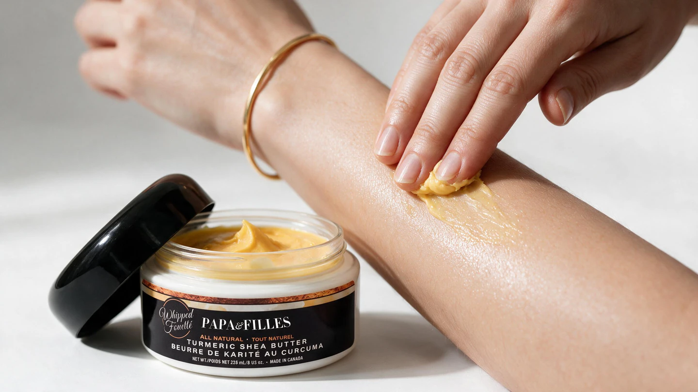 Applying Papa & Filles turmeric shea body butter to an arm